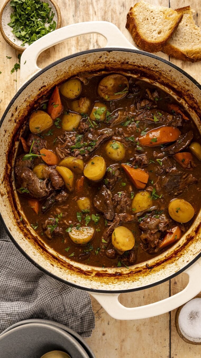 Beef stew with vegetables in Dutch oven.